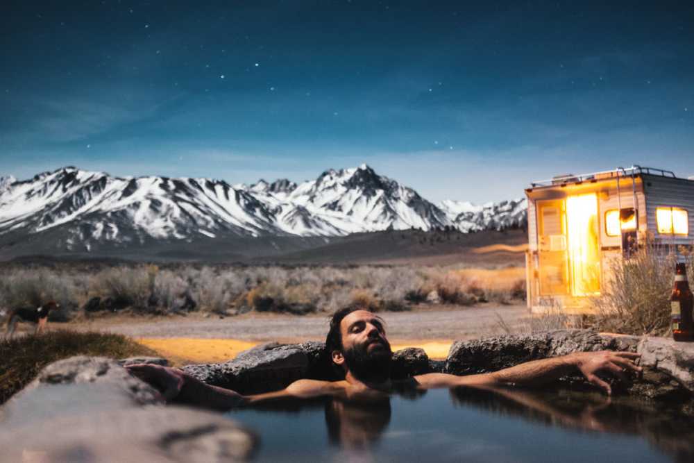 relaxing in a pool by snow mountains