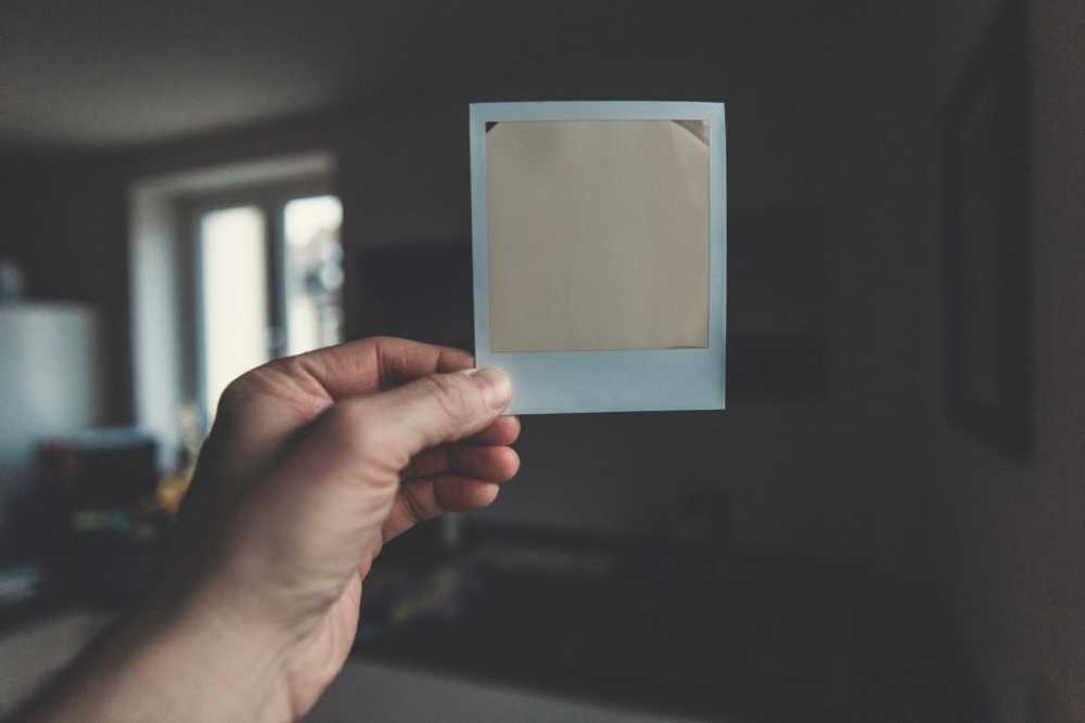 hand holding a white washed polaroid