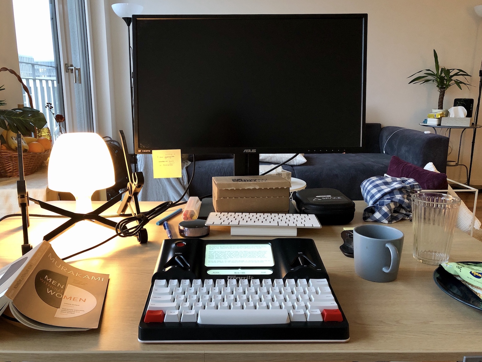 my writing setup at home during National Novel Writing Month in November 2020. That's a Freewrite on the desk