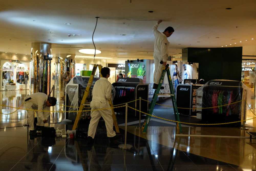 people in white jumpsuits in a mall that look like astronauts